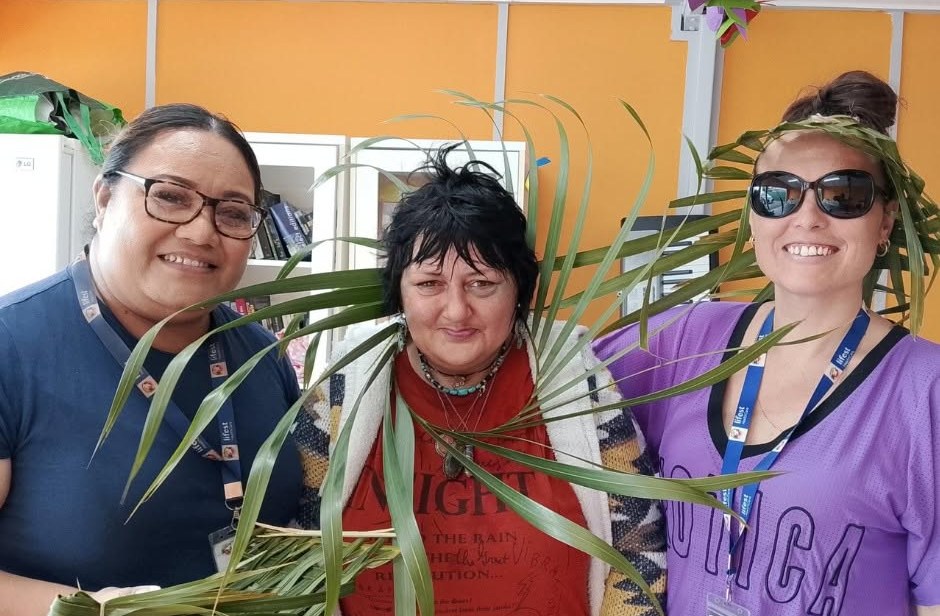 Participants and support workers at a craft session